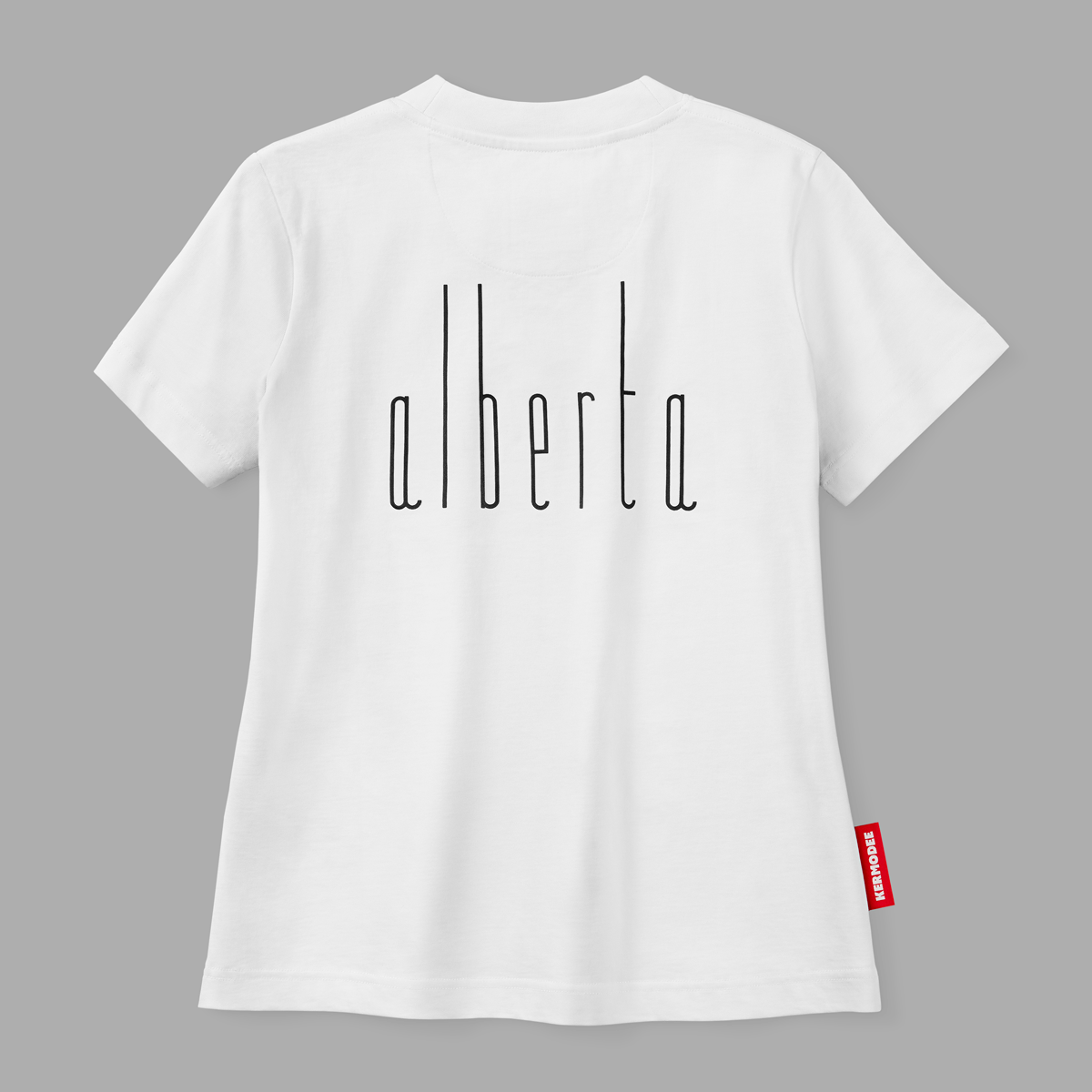 Back view of white t-shirt with thin black vertical Alberta lettering and red KERMODEE side label