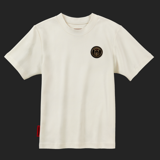 Front view of cream off-white unisex Kermodee Spirit t-shirt with gold-outlined Kermode bear emblem on chest