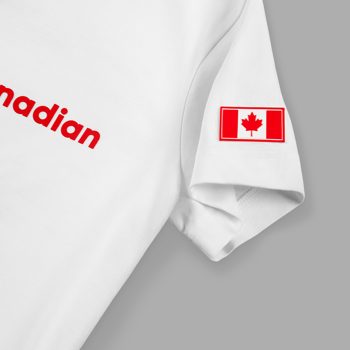 Close-up of Canadian flag patch on left sleeve of white t-shirt