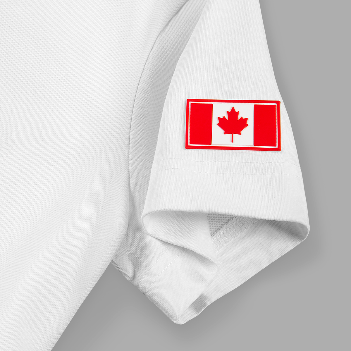 Close-up of Canadian flag patch on left sleeve of white t-shirt