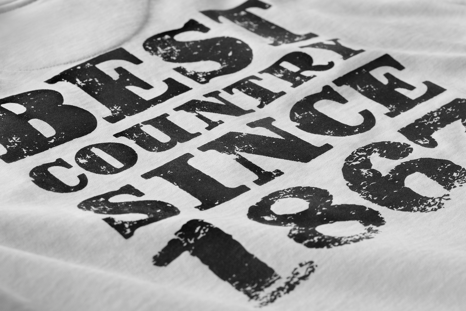 Close-up of distressed black typography reading "Best Country Since 1867" on Kermodee t-shirt.