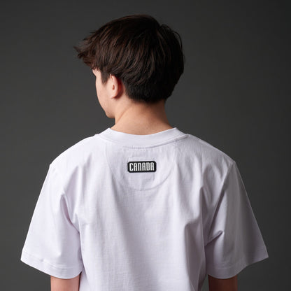 Back view of Strong and Free Proudly Canadian Unisex T-Shirt showing black and white CANADA durable silicone patch and classic unisex fit
