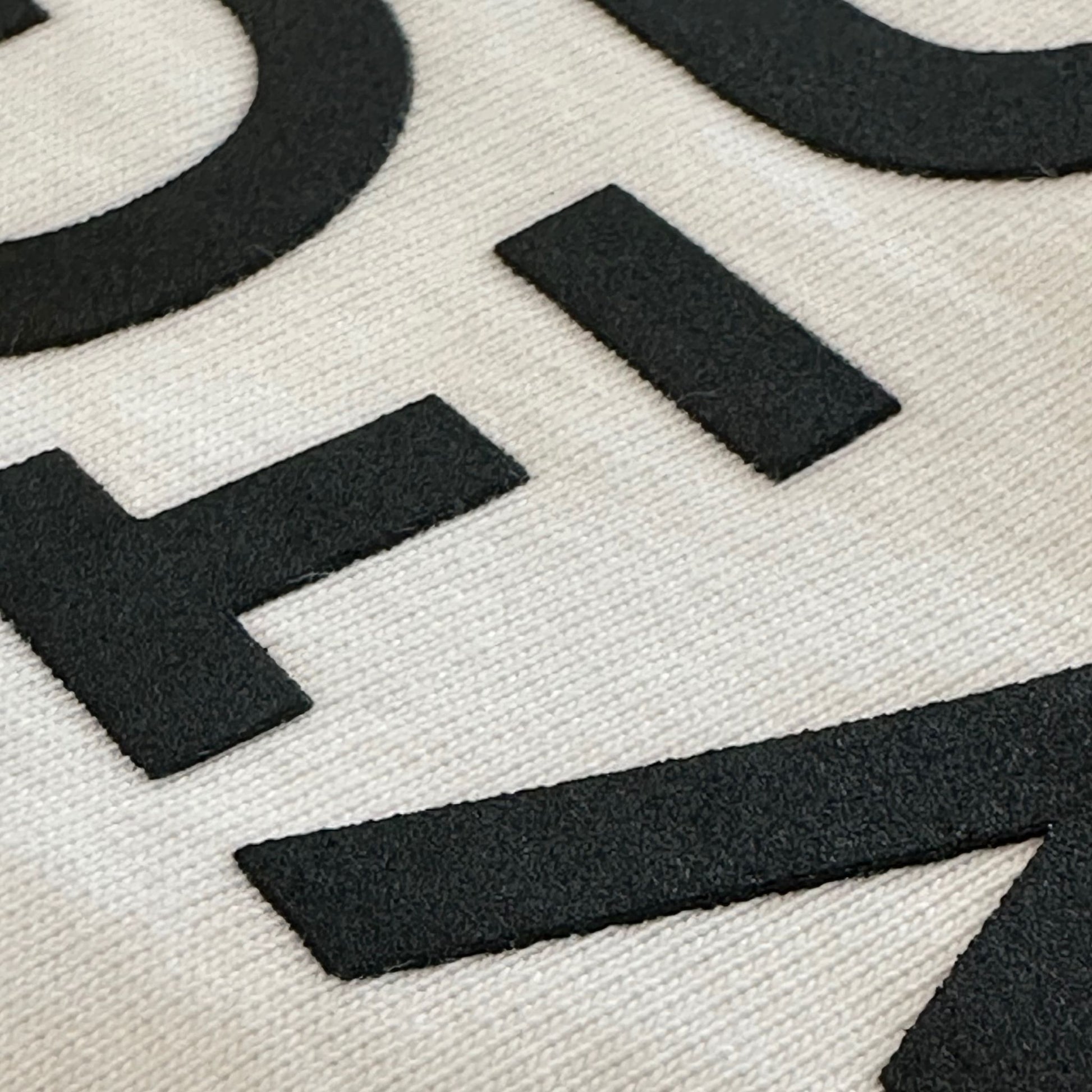 Close-up of raised high-density Proudly Canadian typography on Strong and Free Proudly Canadian Unisex T-Shirt