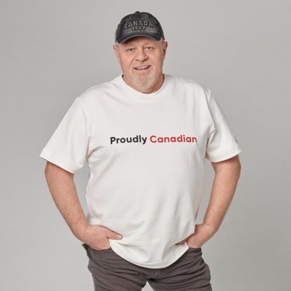 Male model wearing Proudly Canadian Unisex T-Shirt featuring raised high-density red Canadian and black Proudly typography on off-white cotton blend fabric