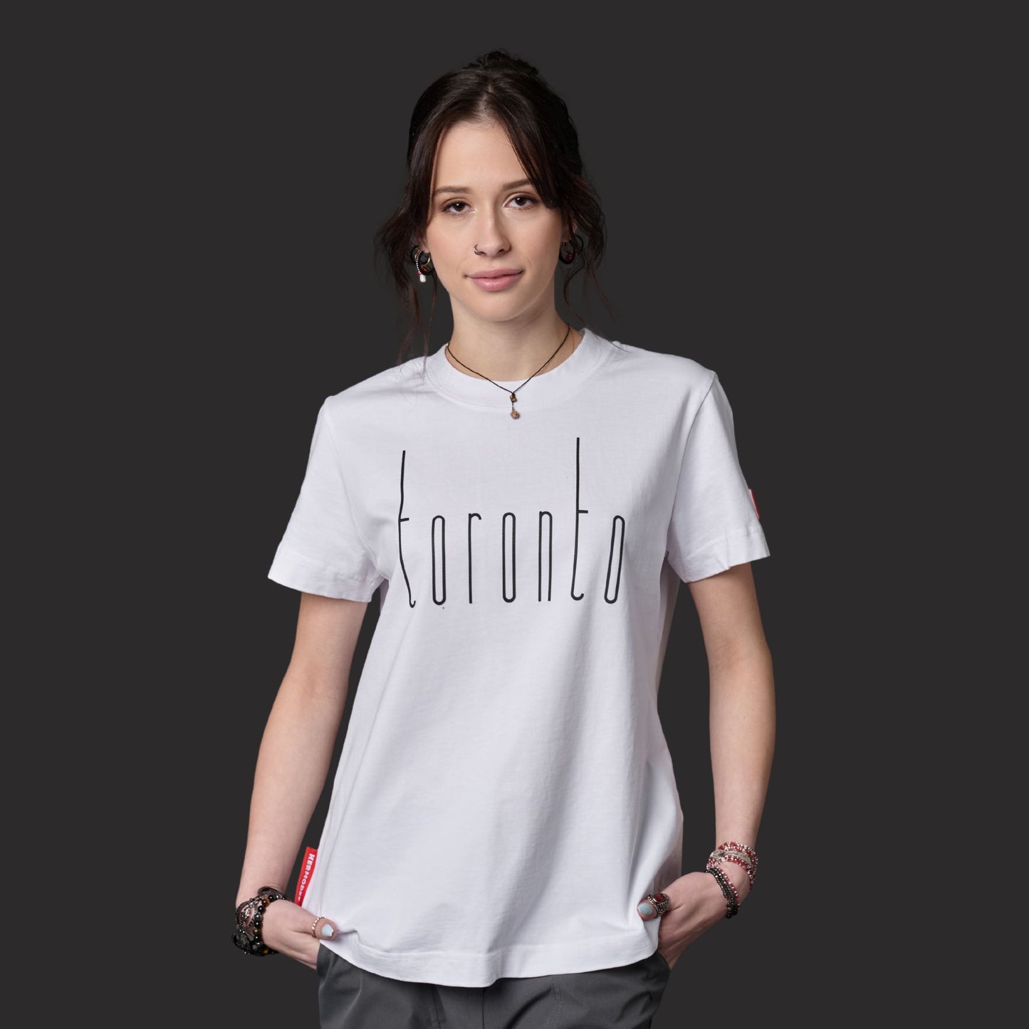 Female model wearing Toronto Ontario Women's T-Shirt with raised high-density Toronto graphic design
