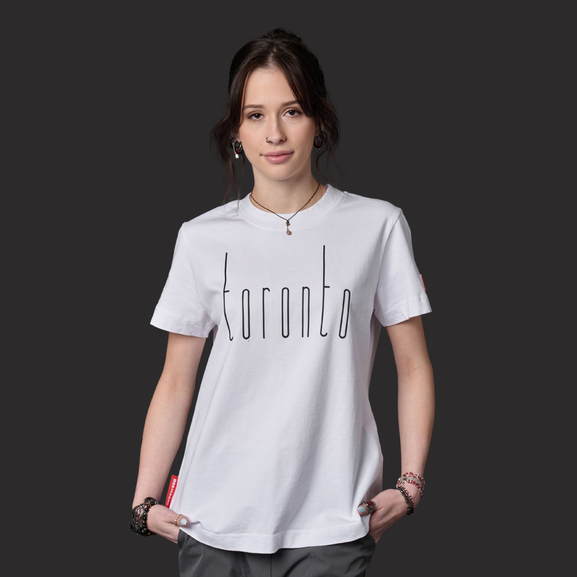 Female model wearing Toronto Ontario Women's T-Shirt with raised high-density Toronto graphic design