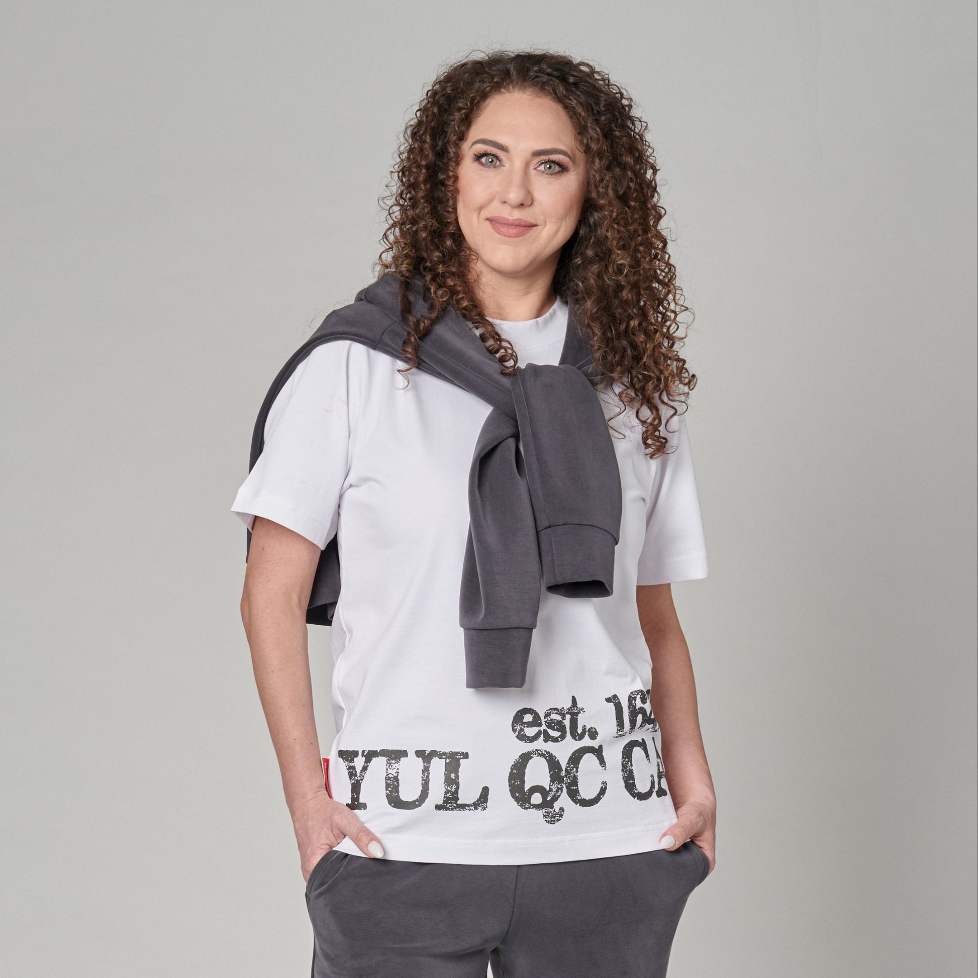 Front view of Montreal Quebec Heritage Unisex T-Shirt featuring distressed YUL QC CA EST. 1642 print and Canadian flag sleeve patch