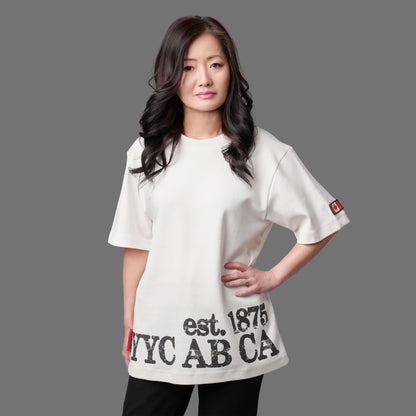 Female model wearing Calgary Alberta Heritage Unisex T-Shirt featuring distressed YYC AB CA EST. 1875 heritage graphic