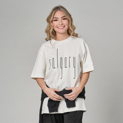 Female model wearing Calgary Alberta Unisex T-Shirt with Canadian City Pride design and raised Calgary lettering