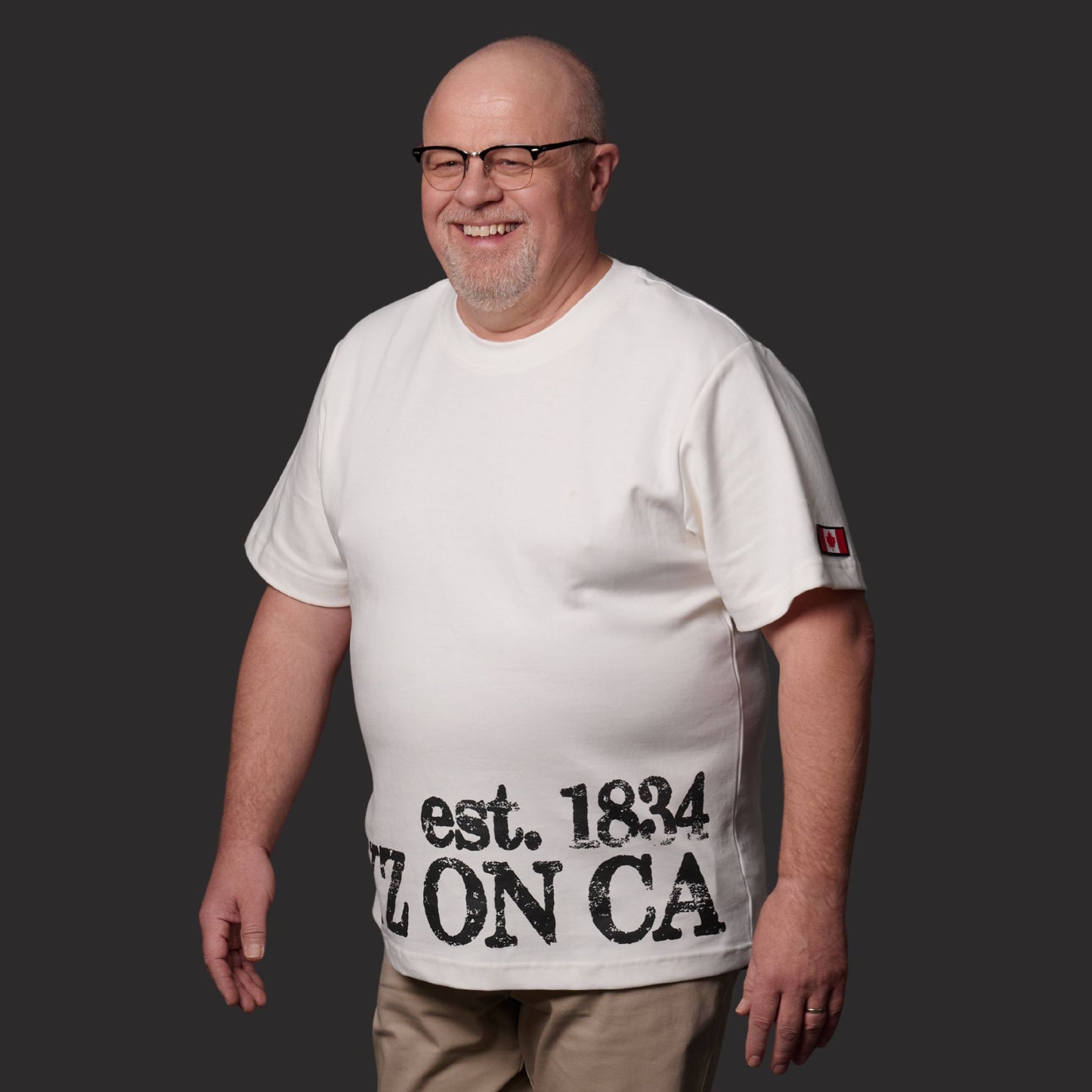 Male model wearing Toronto Ontario Heritage Premium Unisex T-Shirt with distressed YYZ ON CA EST. 1834 heritage print
