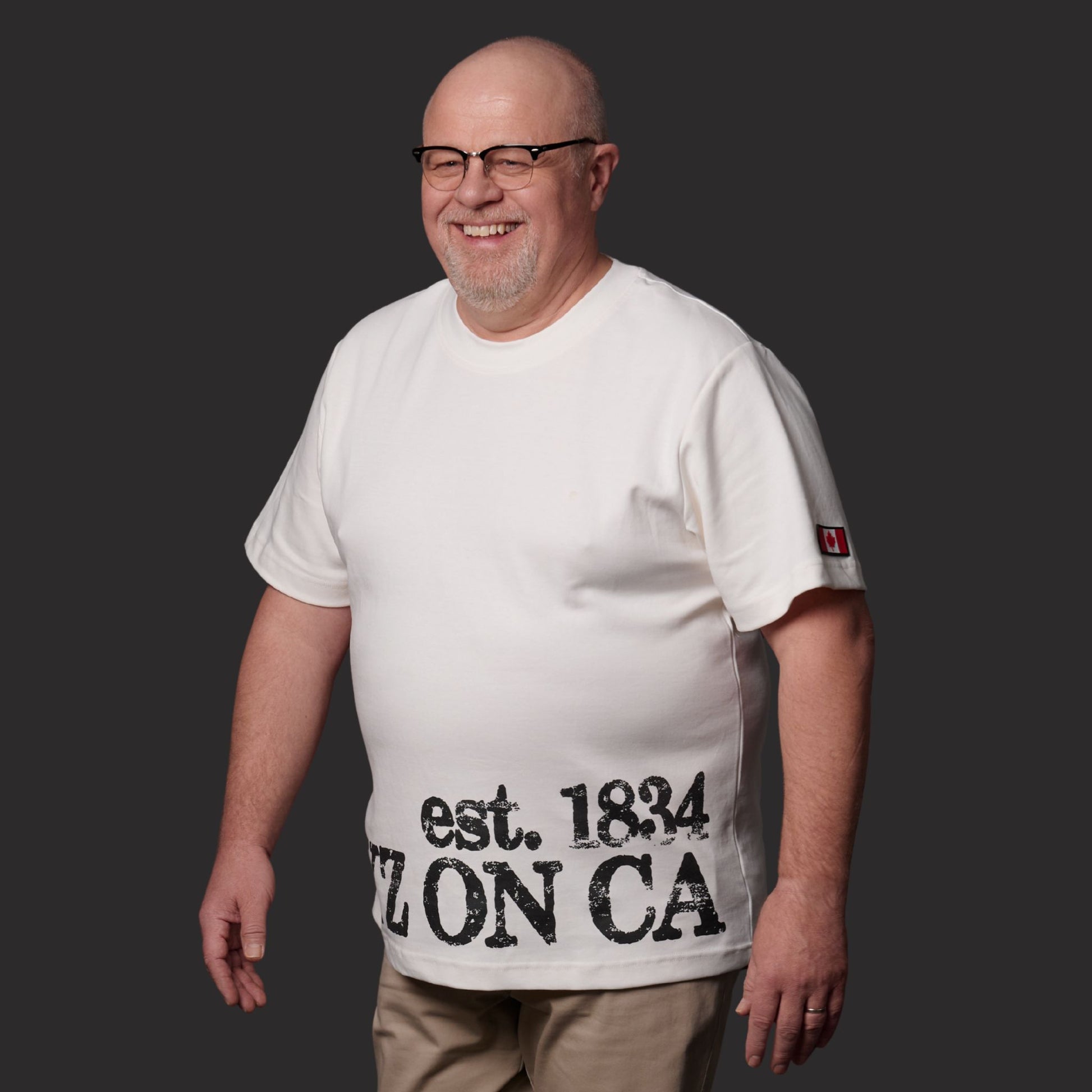 Male model wearing Toronto Ontario Heritage Premium Unisex T-Shirt with distressed YYZ ON CA EST. 1834 heritage print