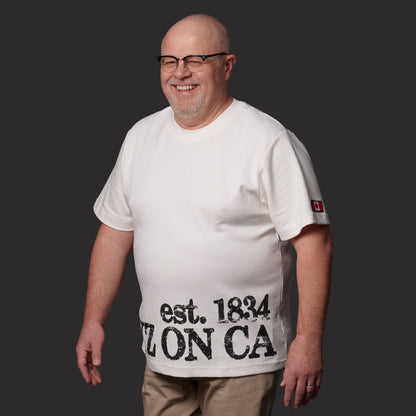 Male model wearing Toronto Ontario Heritage Premium Unisex T-Shirt with distressed YYZ ON CA EST. 1834 heritage print