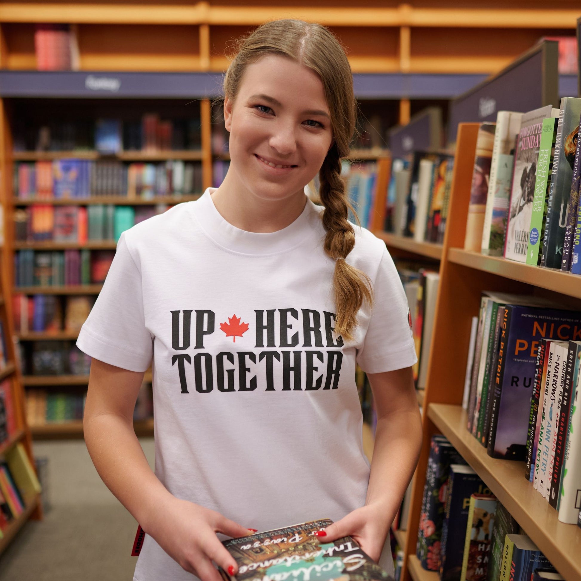 Female model wearing Up Here Together Women's Canada Unity T-Shirt in lifestyle setting