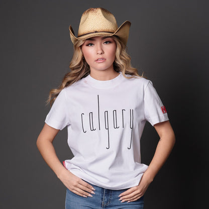 Female model wearing Calgary Alberta Women's T-Shirt featuring raised high-density Calgary typography and Canadian City Pride design