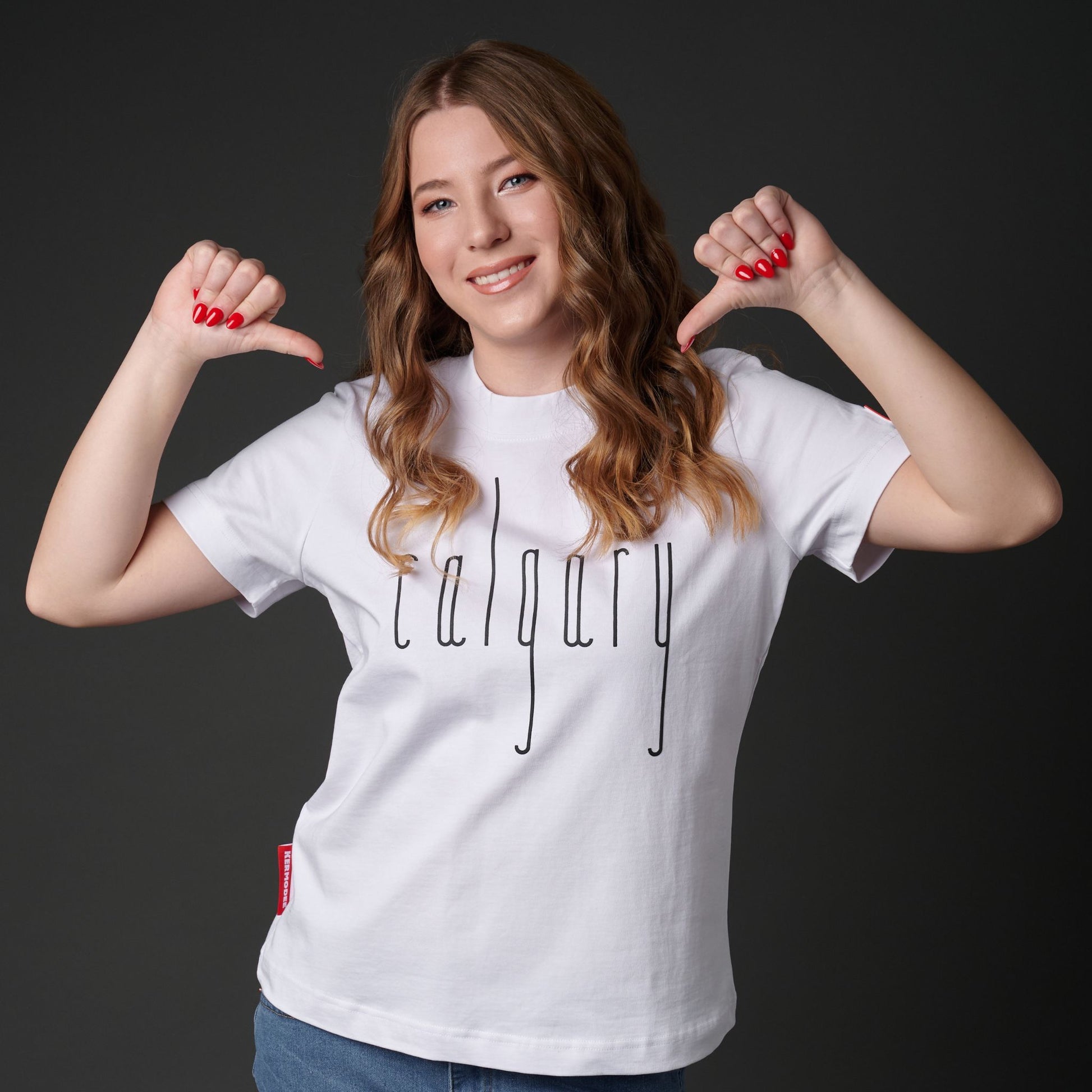 Female model wearing Calgary Alberta Women's T-Shirt with raised high-density Calgary typography on premium white fabric