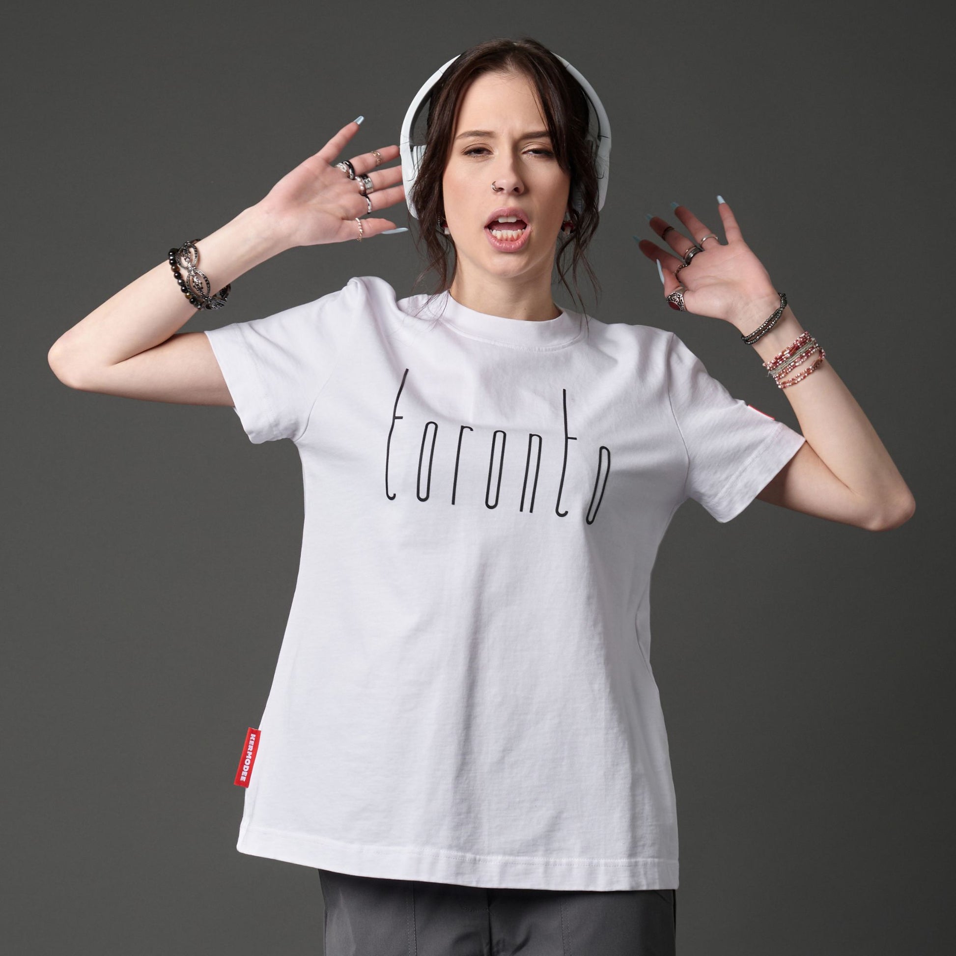 Female model wearing Toronto Ontario Women's T-Shirt featuring raised high-density Toronto lettering and Canadian city pride message