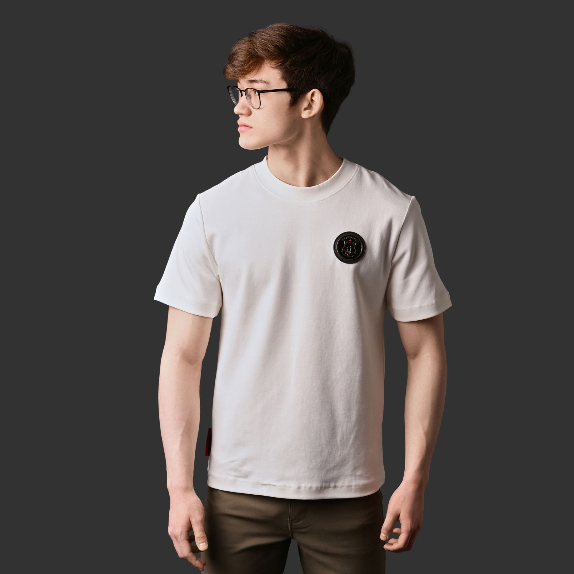 Male model wearing Kermodee Spirit Unisex T-Shirt showing Kermode bear emblem and relaxed fit