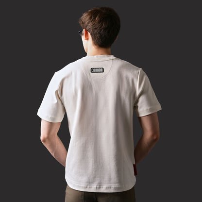 Back view of male model wearing Kermodee Spirit Unisex T-Shirt with black silicone CANADA patch below neckline