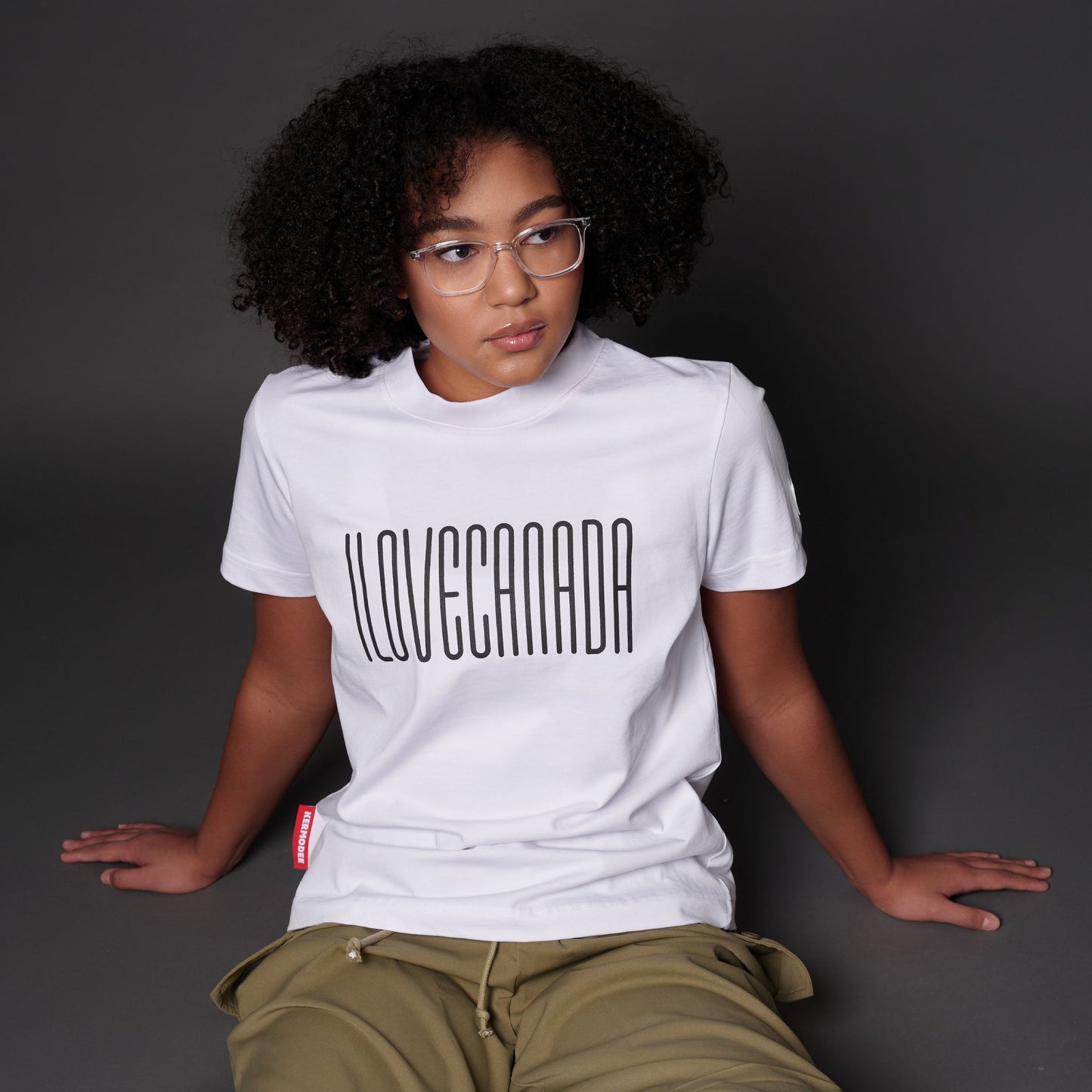 Female model wearing I Love Canada Women's T-Shirt with raised high-density Canadian pride lettering