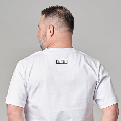 Back view of Strong and Free Proudly Canadian Unisex T-Shirt showing black and white CANADA durable silicone patch and classic unisex fit