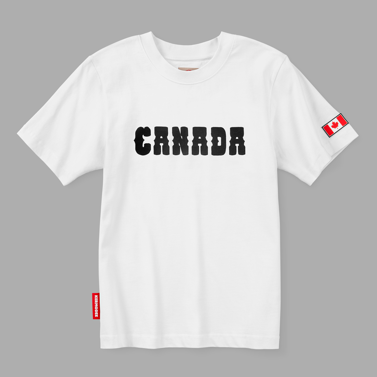 Front view of white Kermodee t-shirt with bold black CANADA lettering and red Canadian flag on sleeve.