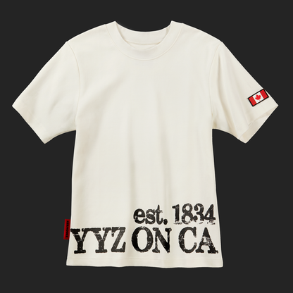 Front of off-white cream Toronto Heritage t-shirt with YYZ ON CA est. 1834 print and Canada flag patch on sleeve