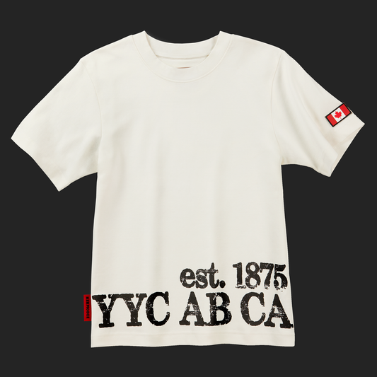 Front of white cream Calgary Heritage t-shirt with YYC AB CA est. 1875 print and Canada flag patch on sleeve