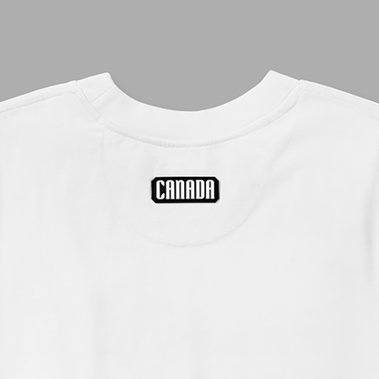 Close-up of black and white Canada patch below back neckline on white t-shirt