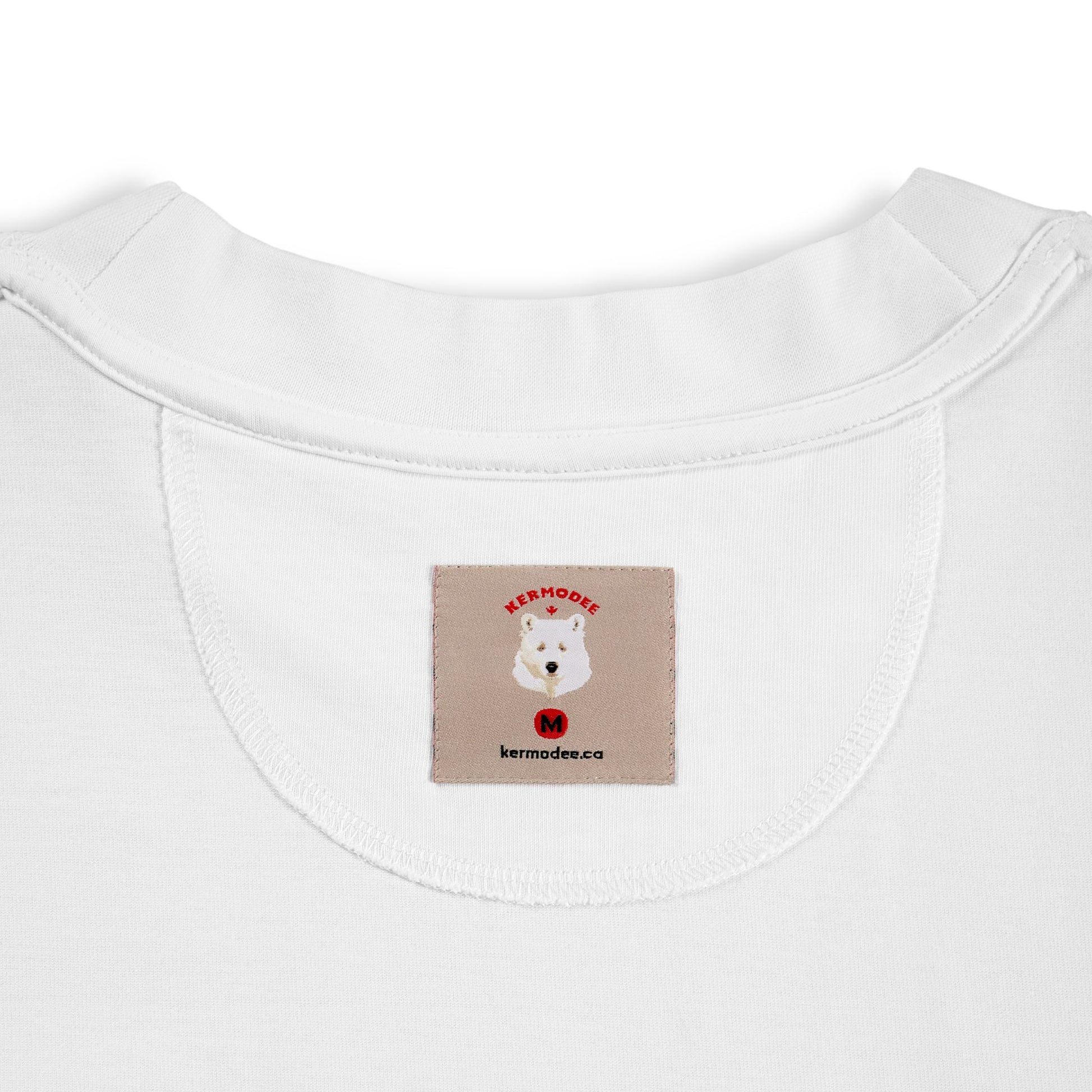 Close-up of signature inside woven neck label featuring the Kermode bear logo on a premium Kermodee T-shirt